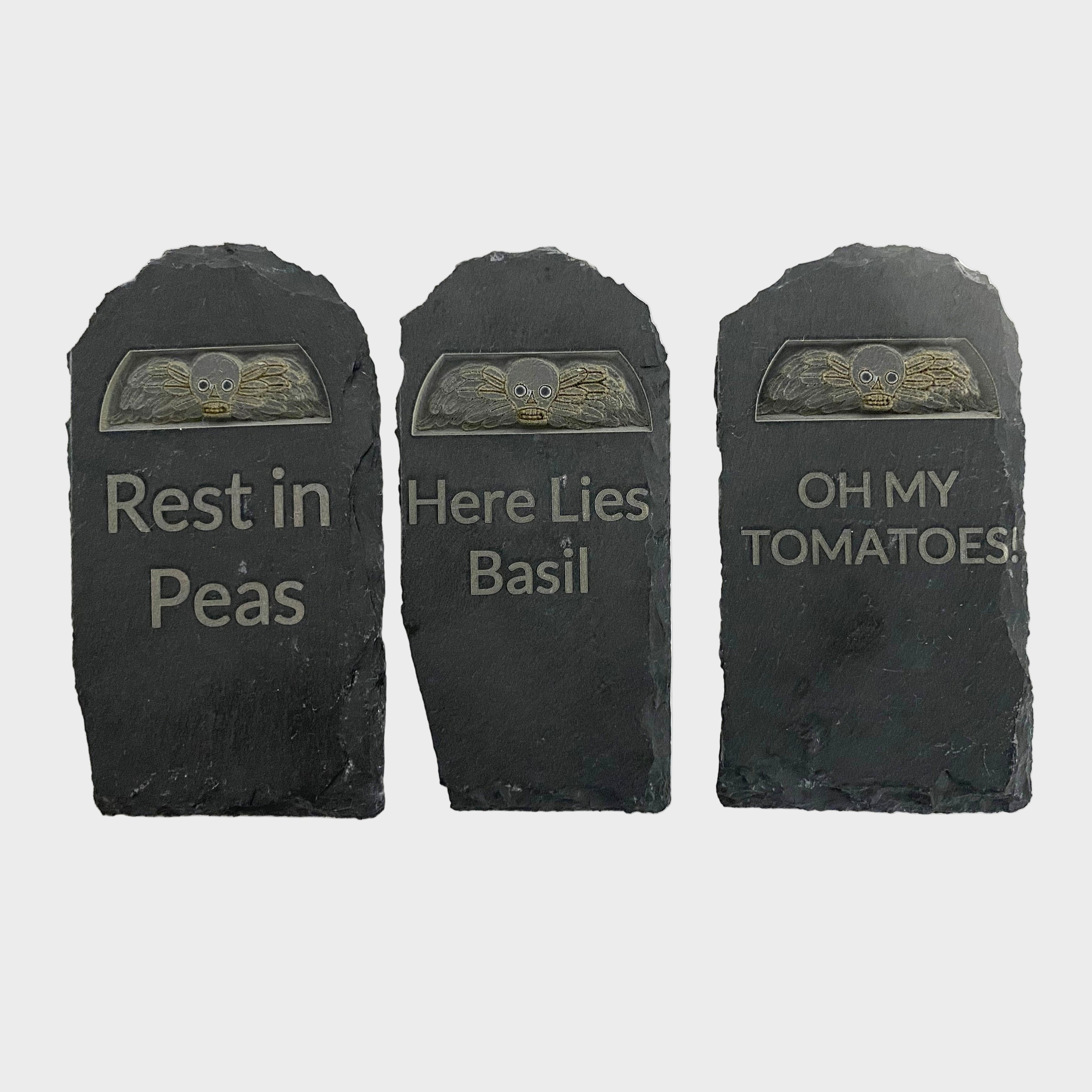 Three black tombstone-shaped decorations with humorous inscriptions on a white background