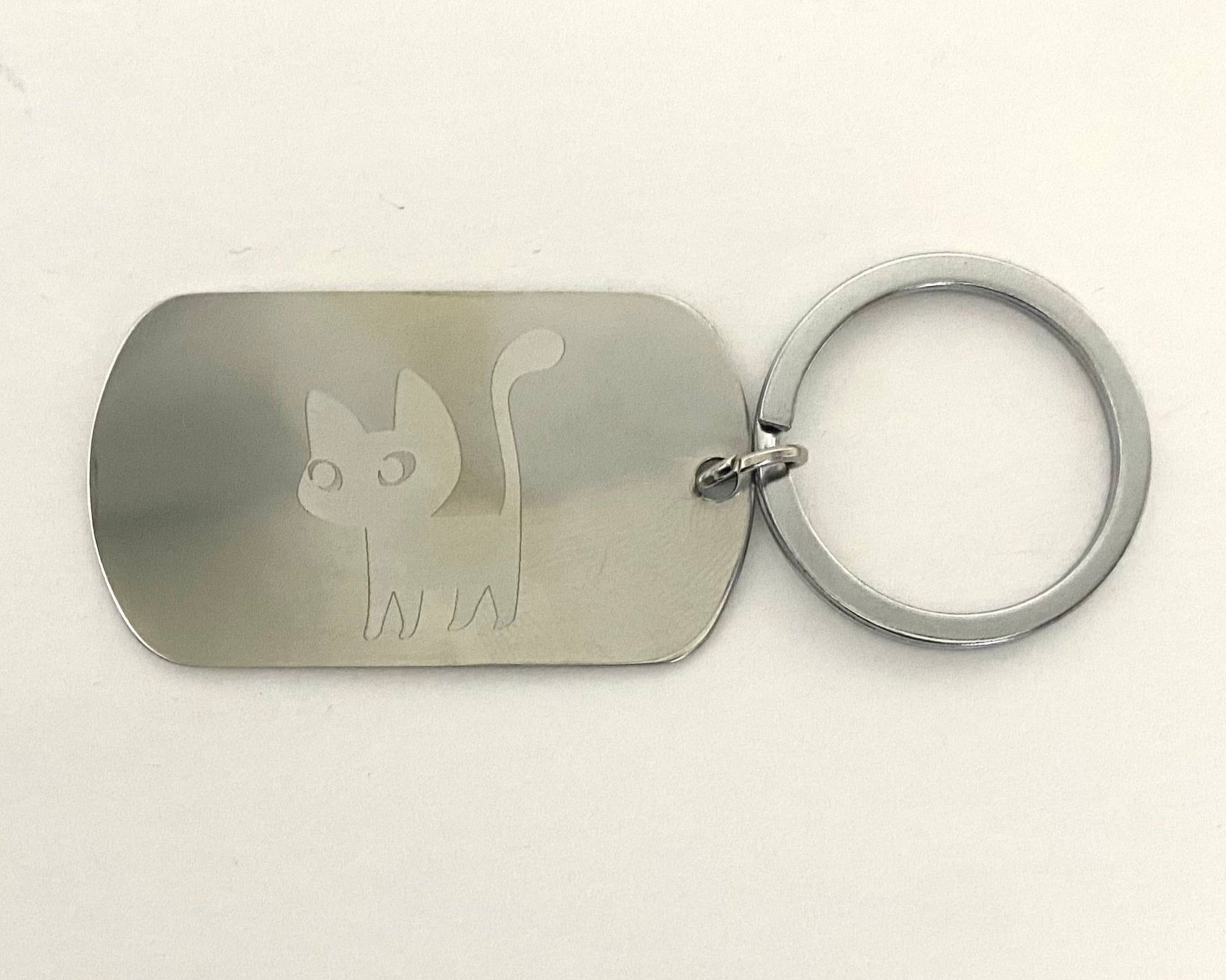 Metal keychain with cat design on a white background